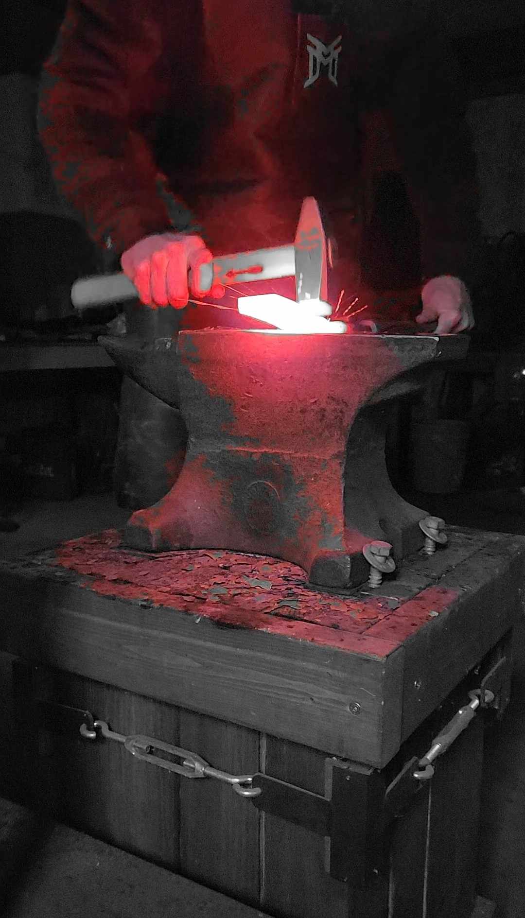Kyle Tatsak hammering steel at the forge